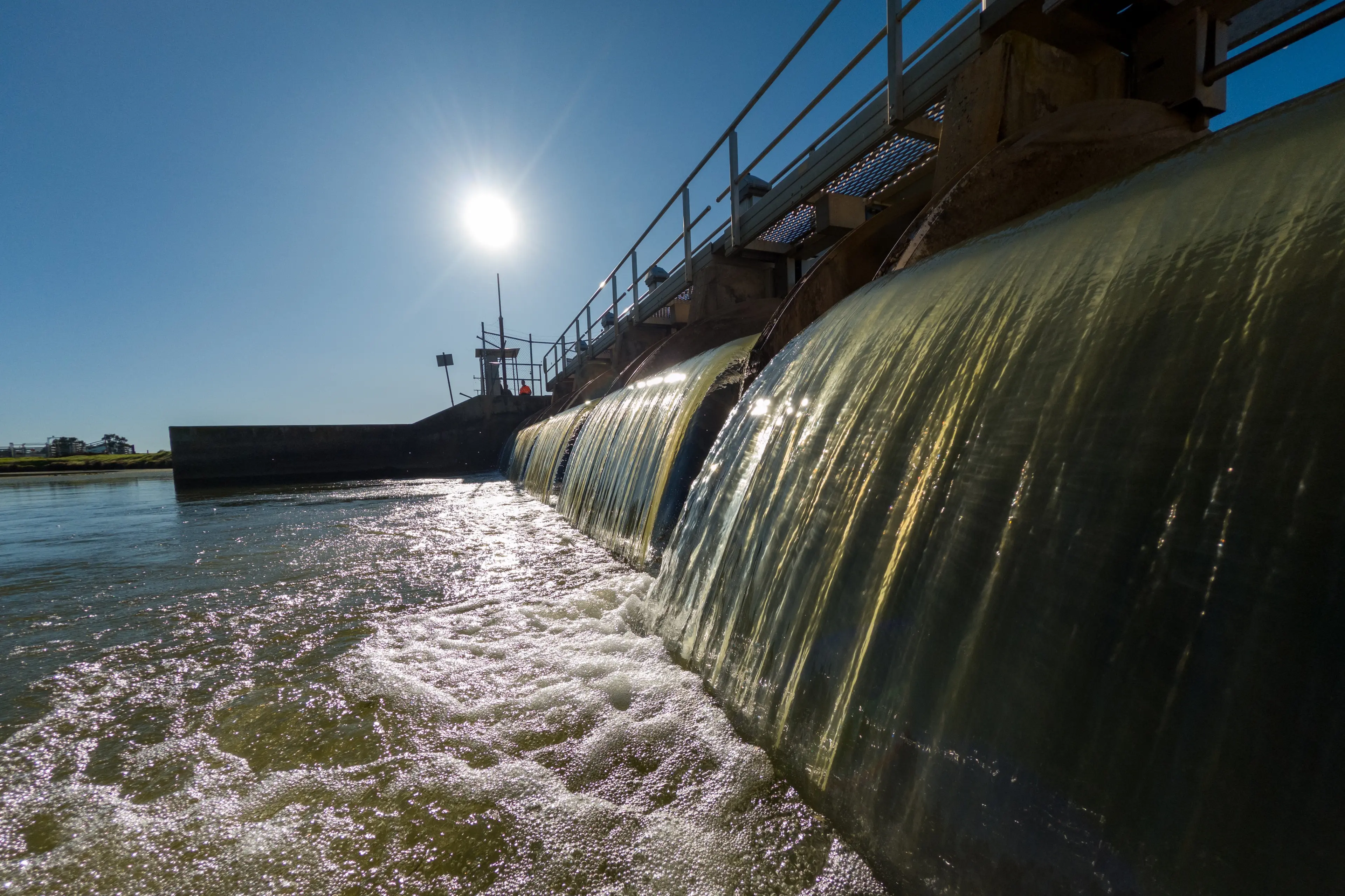 <p>PLEASE EXPLAIN: Water flowing through a flume gate, which is an automated water control device used to measure and regulate water flow based on demand and environmental targets.</p>\\n