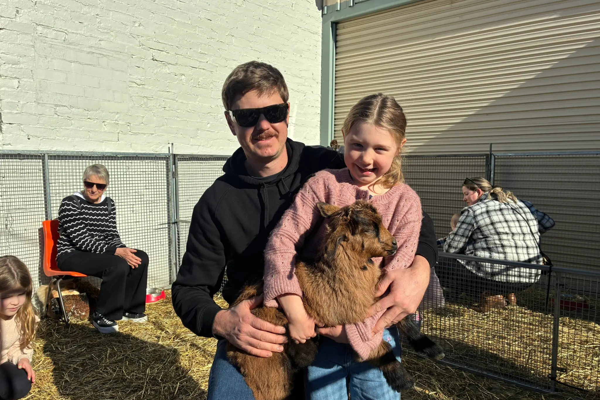 <p>CUDDLES ALL ROUND: Piper (6) having a cuddle with Layla the goat and her dad Phillip Weir at the Funky Op Shop on Monday morning thanks to a visit from Hay Ho Animal Nursery. . PHOTOS: Jordan Duursma </p>\\n