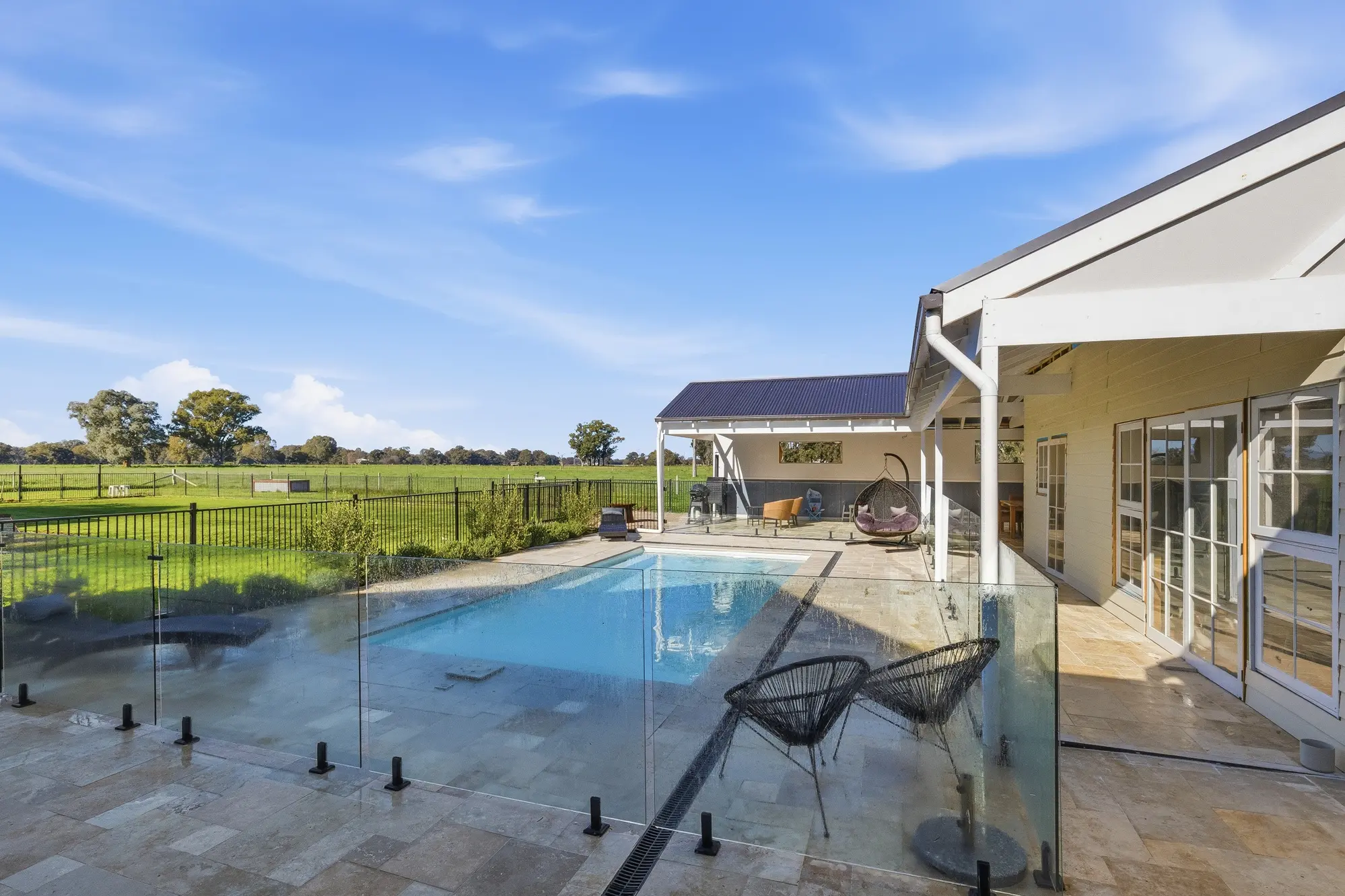 <p>This rural property has an inground mineral pool complete with heat pump, large paved outdoor undercover entertaining area, plus partially completed pool house/gym.</p>\\n