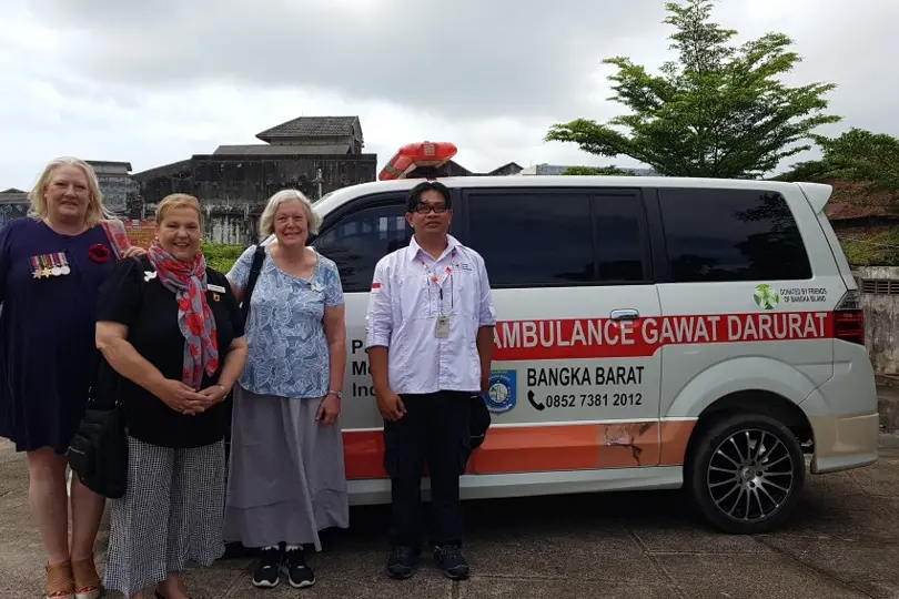 <p>CLOSER TIES: (From left) Phillippa Dickson, niece of Matron Irene Drummond who was killed on Radji Beach, Arlene Bennett, Judy Balcombe and Mr Dery Aryandi from the Muntok Red Cross with the ambulance gifted to the Bangka Island Red Cross in 2020. It was Matron Drummond who directed the group of civilian women and children to walk away from the beach towards Muntok and this saved them from the 1942 massacre. The group was led by two wounded soldiers and an elderly Australian farmer, John Dominguez from Wandiligong. Mr Dominguez and his wife Agnes later died in Muntok prison camp.</p>\\n