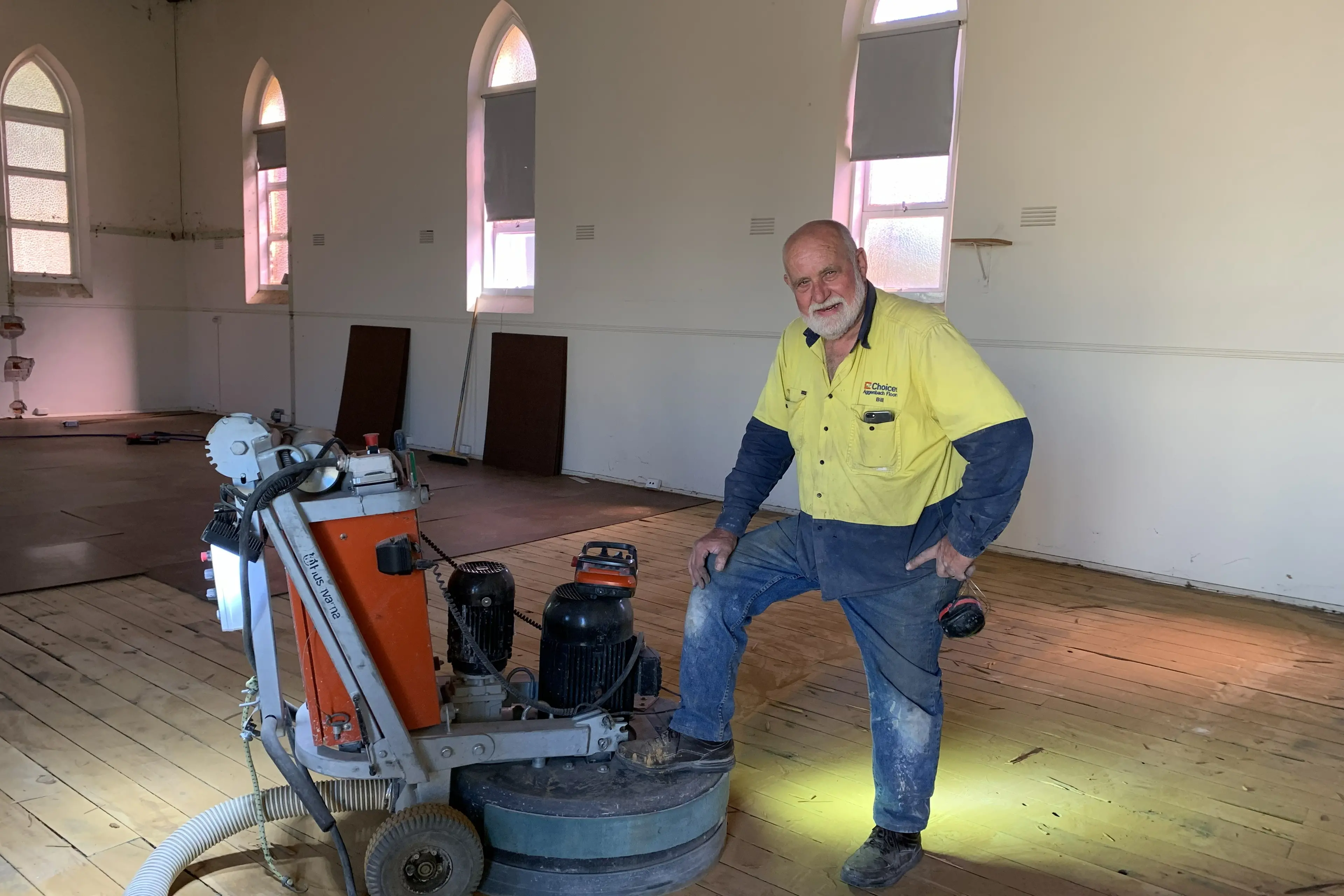 <p>THE WORKER: Bill Aggenbach loved the hands-on nature of the flooring business, seen here on the sander during work on the former Wangaratta Baptist Church in Baker Street..</p>\\n