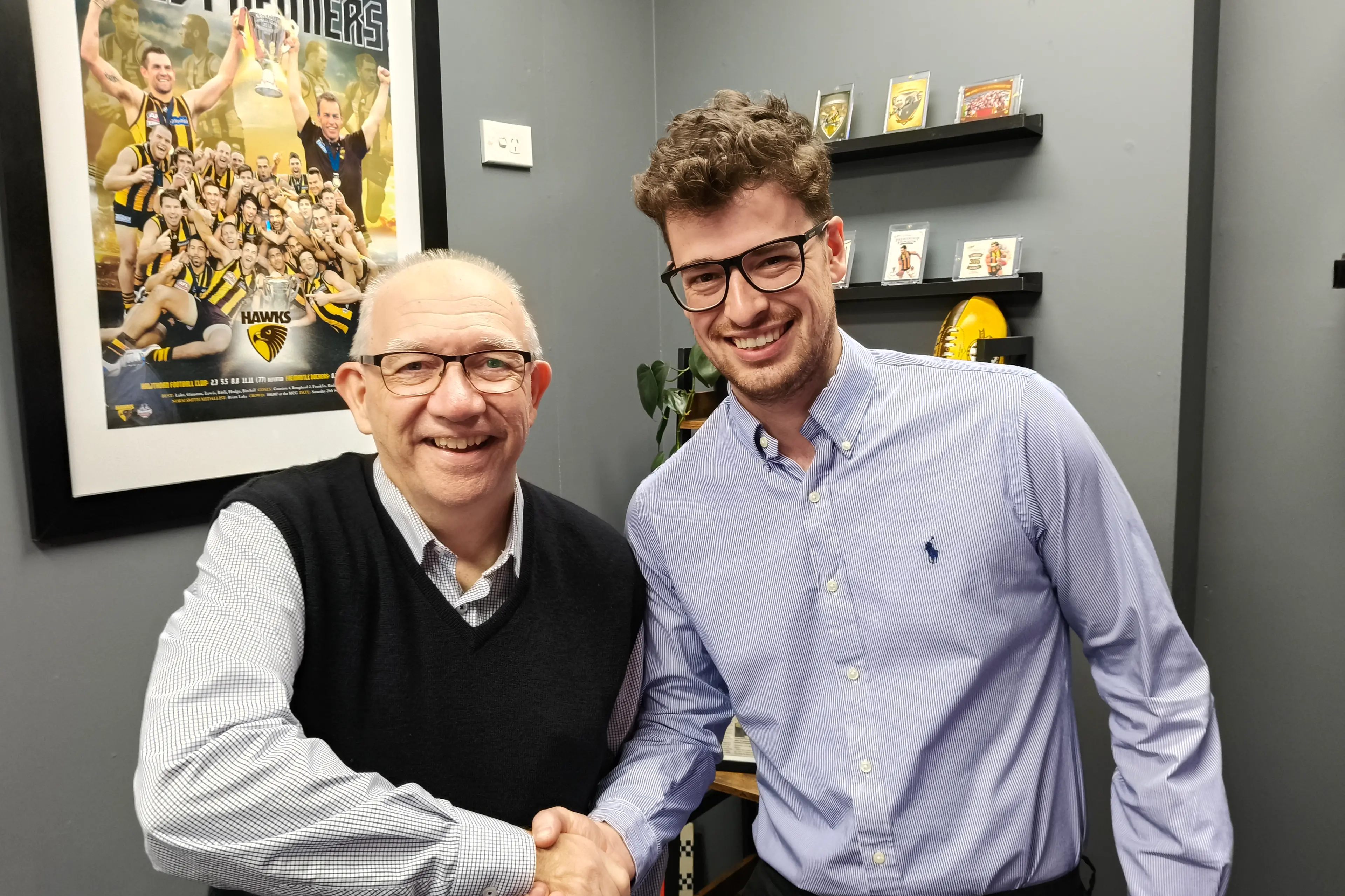 <p>PLAYING TO WIN: Footy tipster extraordinaire Jacob Schutte is congratulated by Wangaratta Chronicle advertising sales representative Mark Dillow on his win. PHOTO: Shane Douthie</p>\\n