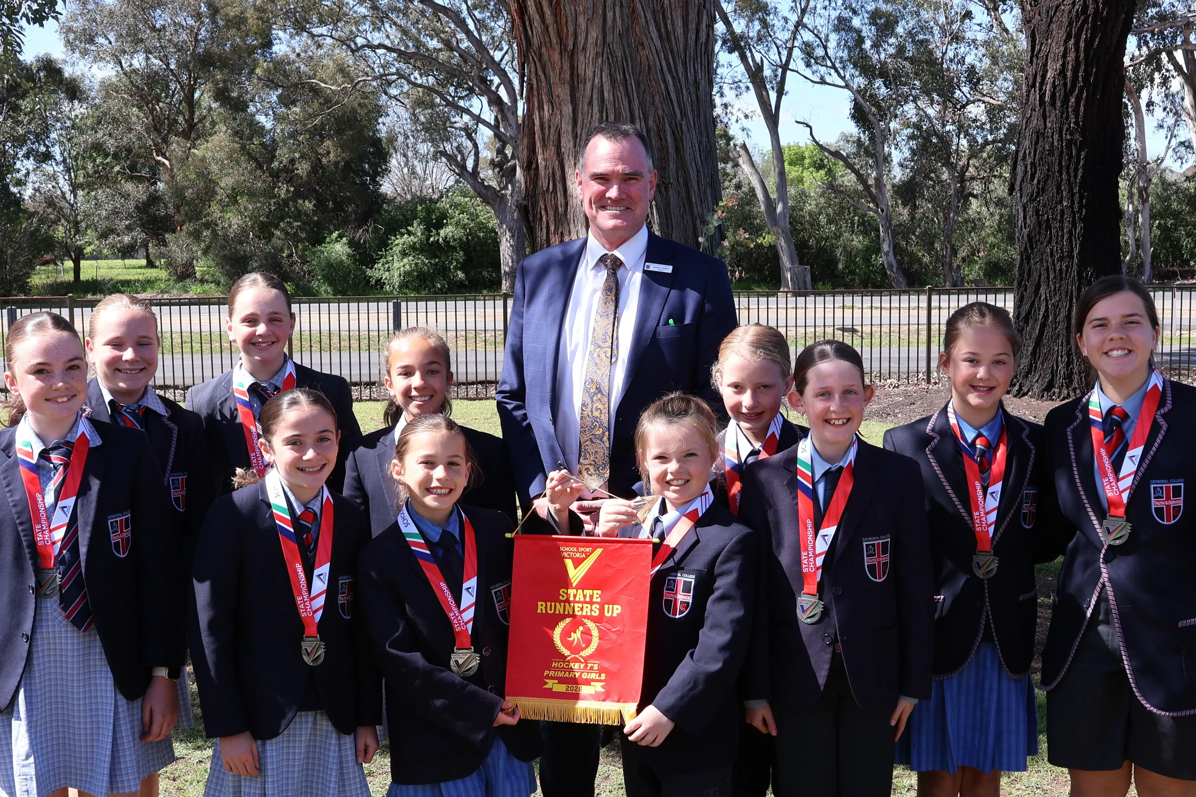 <p>HOCKEY STARS: Cathedral College Wangaratta\\'s primary state hockey runners-up team presents principal Jeremy Godden with the pennant. Pictured with Mr Godden are (back) Lilly Stevenson, Maddie Van Der Zalm, Phoebe Cresswell, Lily Wood, Milla Graham, Eliza Taylor, (front) Lexi Clark, Eloise Sammut, Pippa Reilly, Madelyn Benton and Leirah Hallinan. Absent: Amelie Reilly.</p>\\n