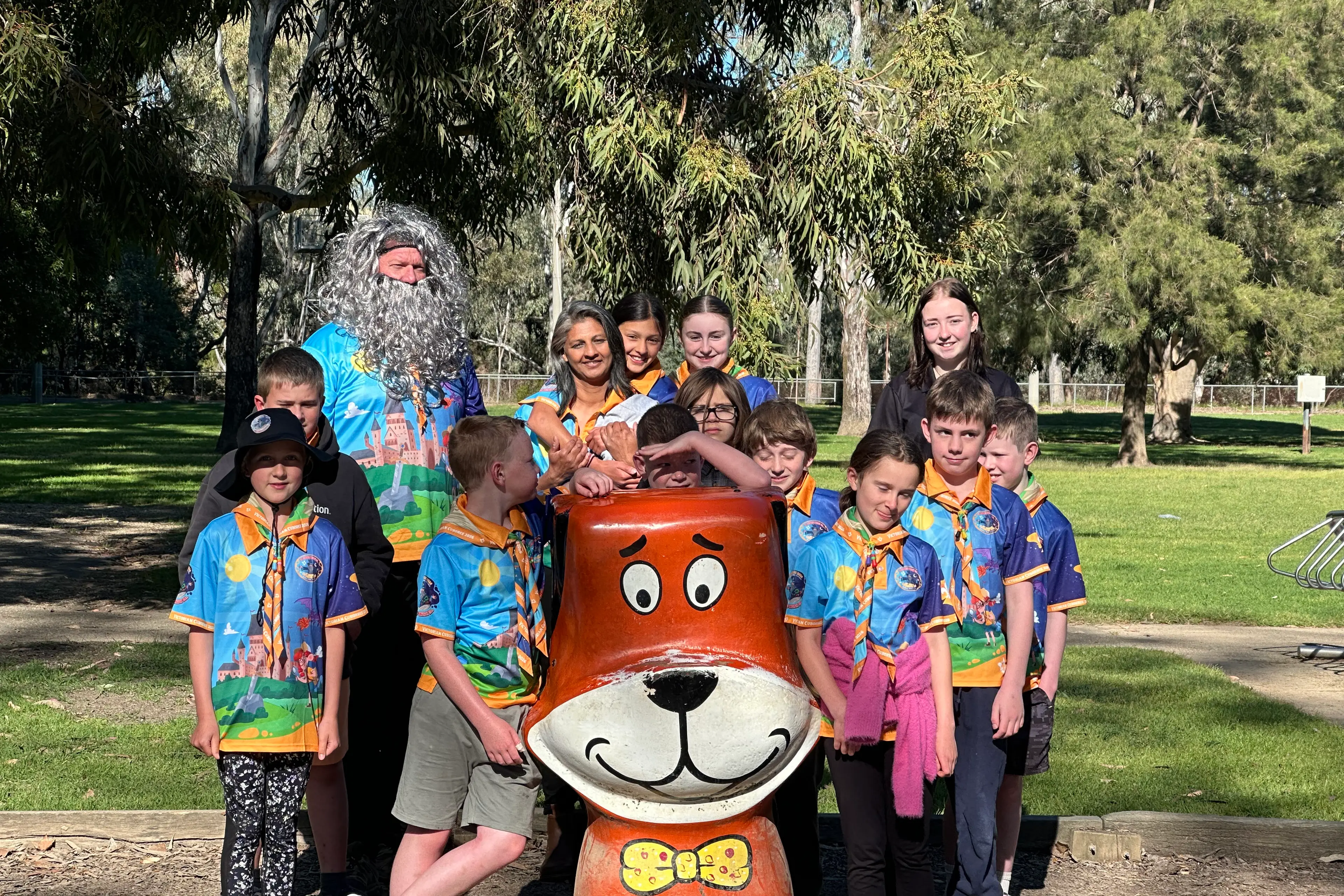 <p>MISS YOU ALREADY:1st Yarrunga Scout Group leader Russell Taylor and parent volunteer Bipa Bell with the excited Cubs as they farewell \"Yogi Bear\" while waiting for their bus to Gembrook.</p>\\n