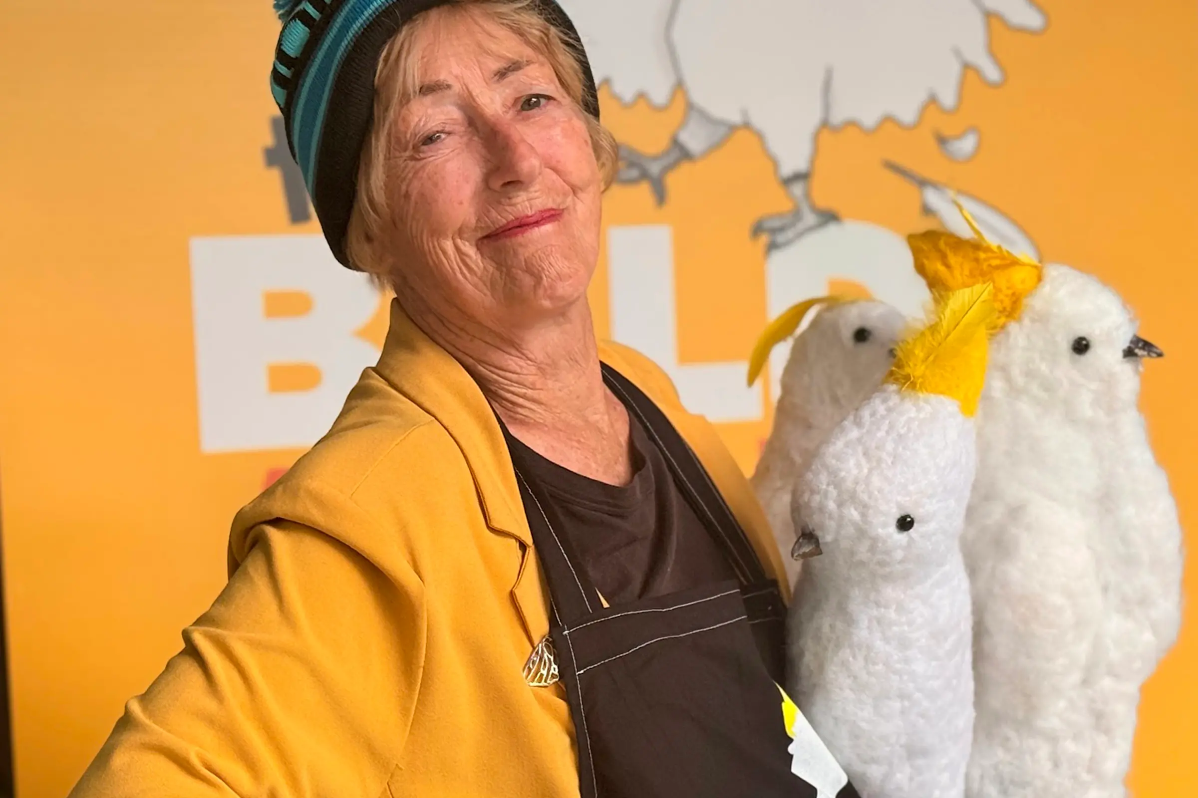 <p>READY FOR ACTION: Helena Gibson (Aunty Baldy), co-coordinator of the Bald Archy Violet Town exhibition, with some of the delightful cockatoo characters lovingly created by members of Violet Town Community House. The exhibition\\u2019s famously unconventional judge is Maude the Cockatoo, who casts her discerning eye over the artworks and selects the winner. They will soon be perched among the trees, ready to welcome visitors to the exhibition. PHOTO: Serana Hunt-Hughes</p>\\n