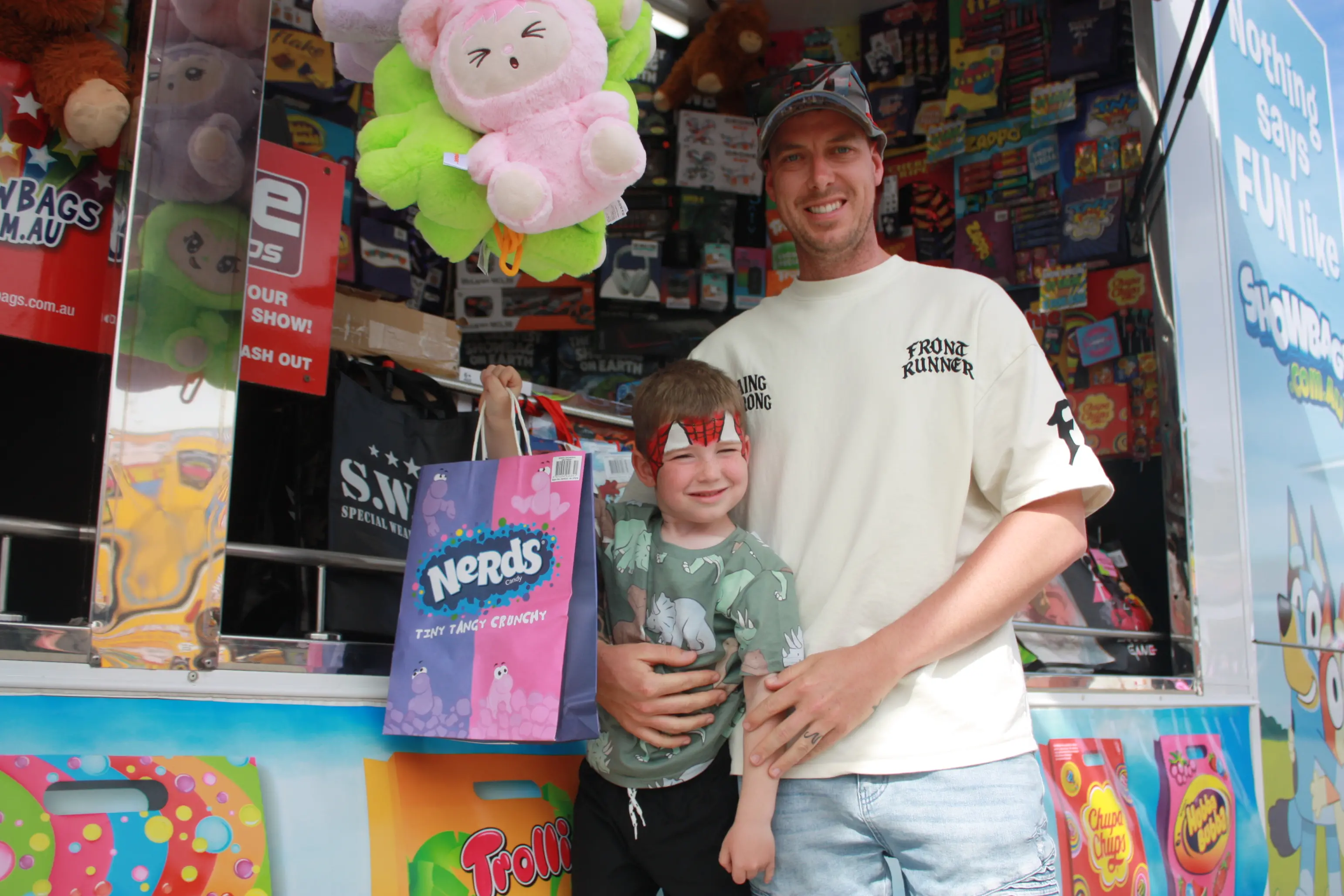<p>SHOWBAG SELECTION: Picking out a show bag was a serious business for three-year-old Rhys Plum, pictured with his dad Brodie. </p>\\n