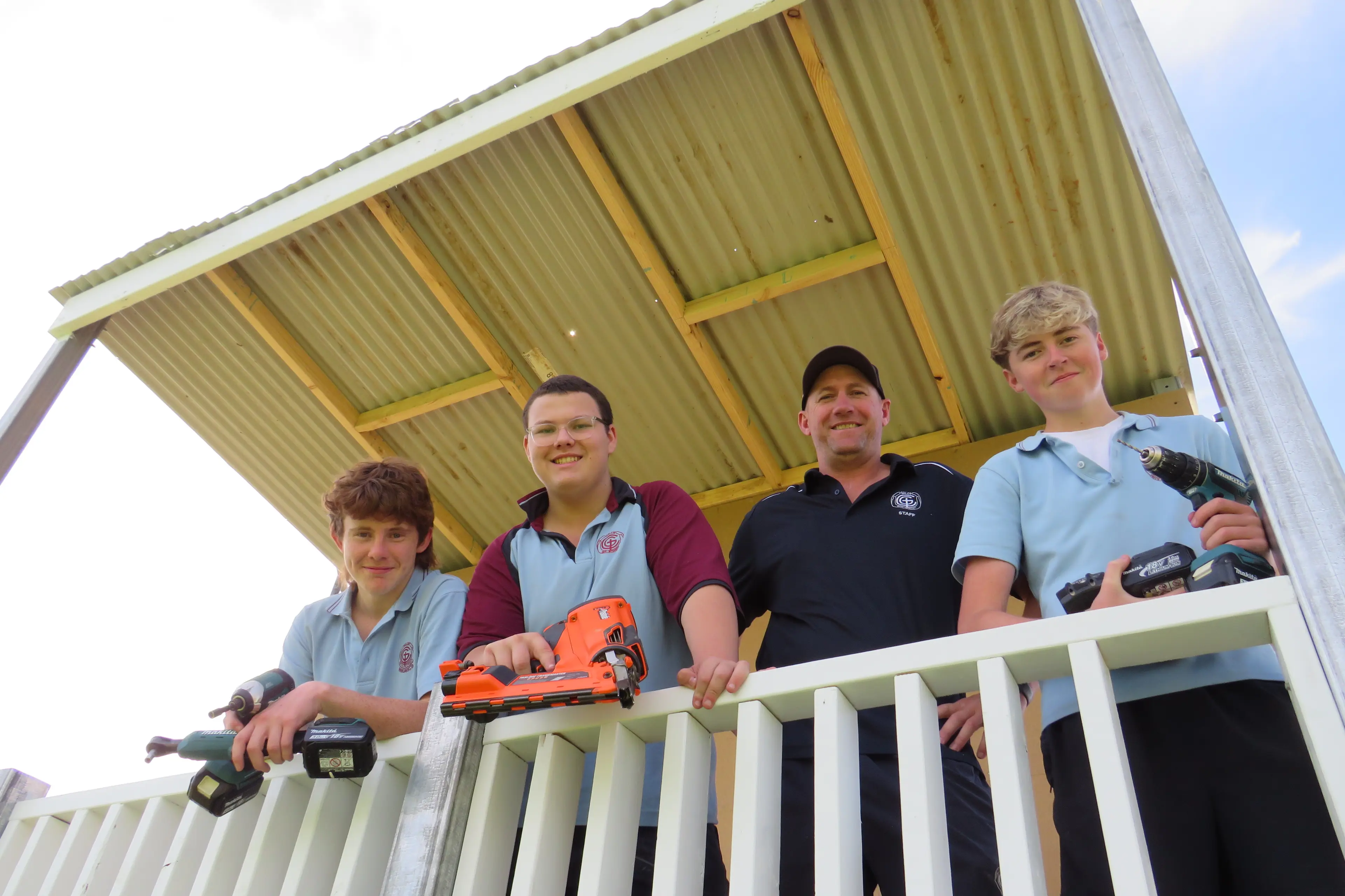 <p>LEAVING THEIR MARK: Galen Catholic College VET (Vocational Education and Training) building and construction teacher Trent Allan with students Daemon Whybrow, Harry Saunders and Harvey Fitzgerald, who have been working on the new scoreboard at the school. PHOTO: Simone Kerwin </p>\\n