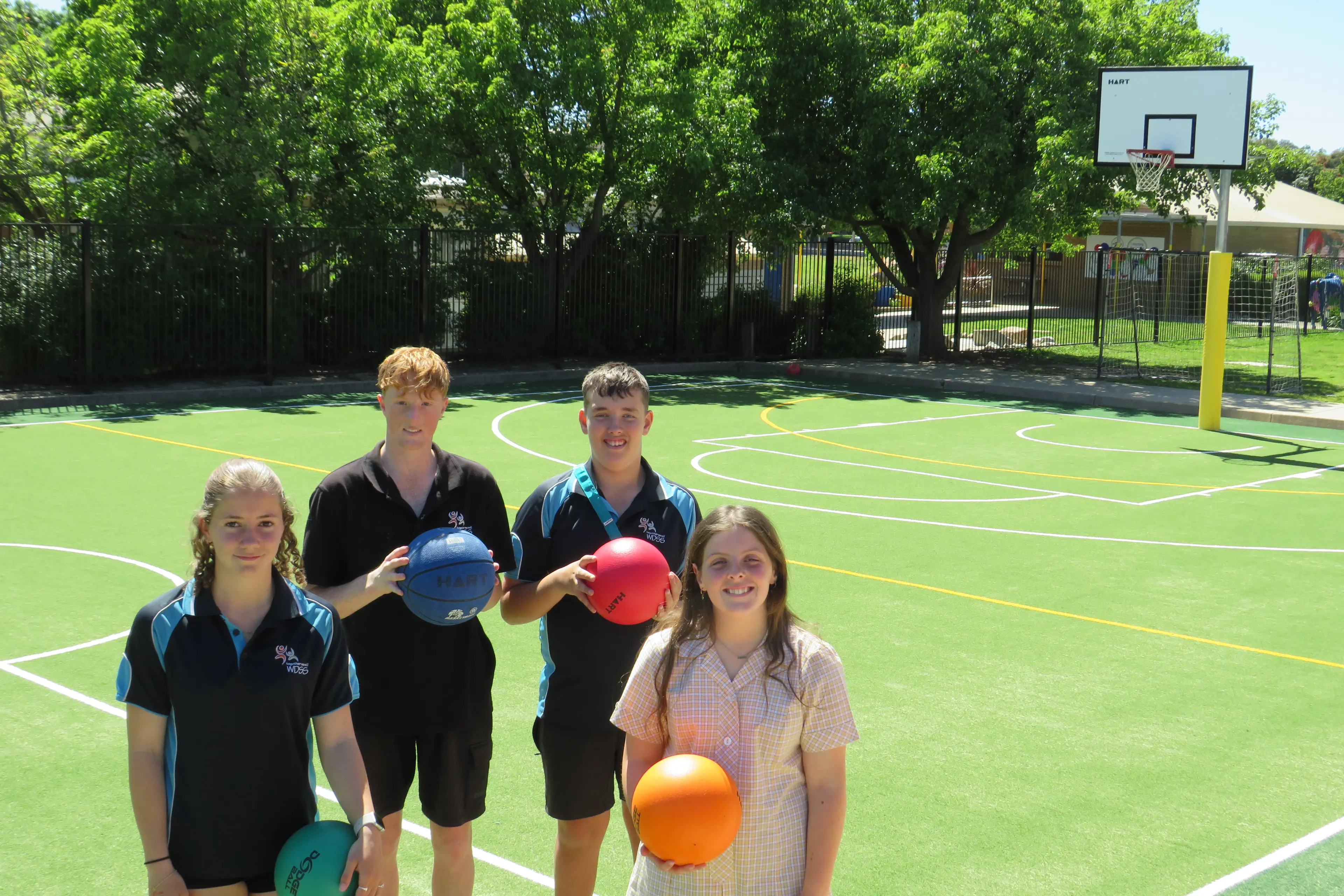 <p>RAPT IN NEW SURROUNDS: Wangaratta District Specialist School students Lara Pearson, Harry White, Chuck Curtis and Lily Whalley show off the new synthetic grass court at the school, funded with the help of an Active Schools grant. PHOTO: Simone Kerwin </p>\\n